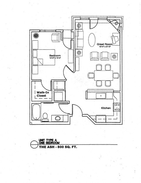 A floor plan of a one bedroom apartment with a great room, bedroom, walk-in closet, and kitchen.